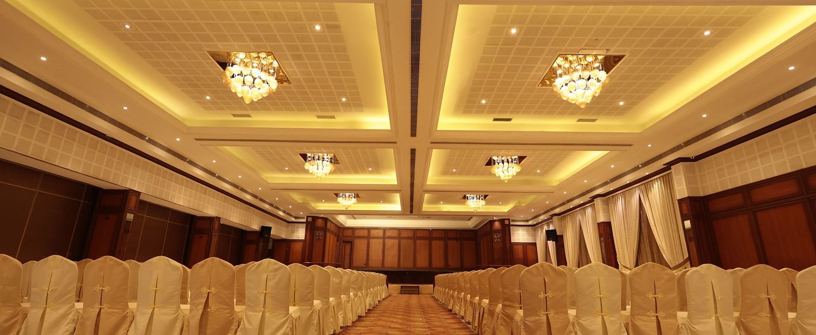A front view of a banquet hall with chairs arranged on both sides | Cenneys Gateway