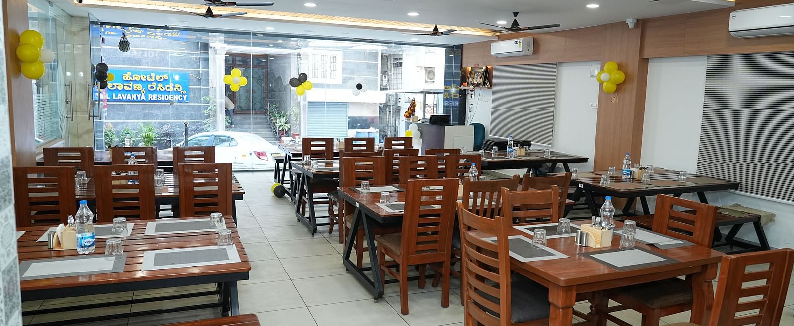 full view image of the dining area with chairs arranged according to the dining tables - Hotel Grand Sigma