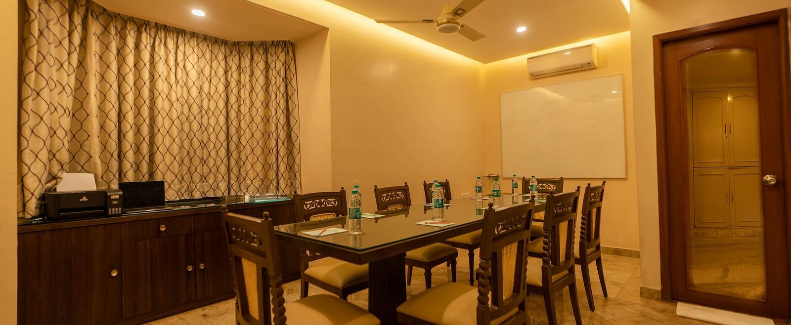 A meeting room at Hotel Pai Viceroy Jayanagar featuring seating for 8 persons, a white board and air-conditioning
