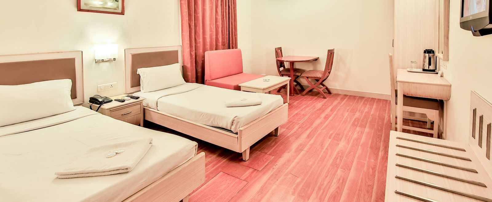 Superior Room at Hotel Shantiniketan with twin beds and a television in Hyderabad near Ramoji Film City.