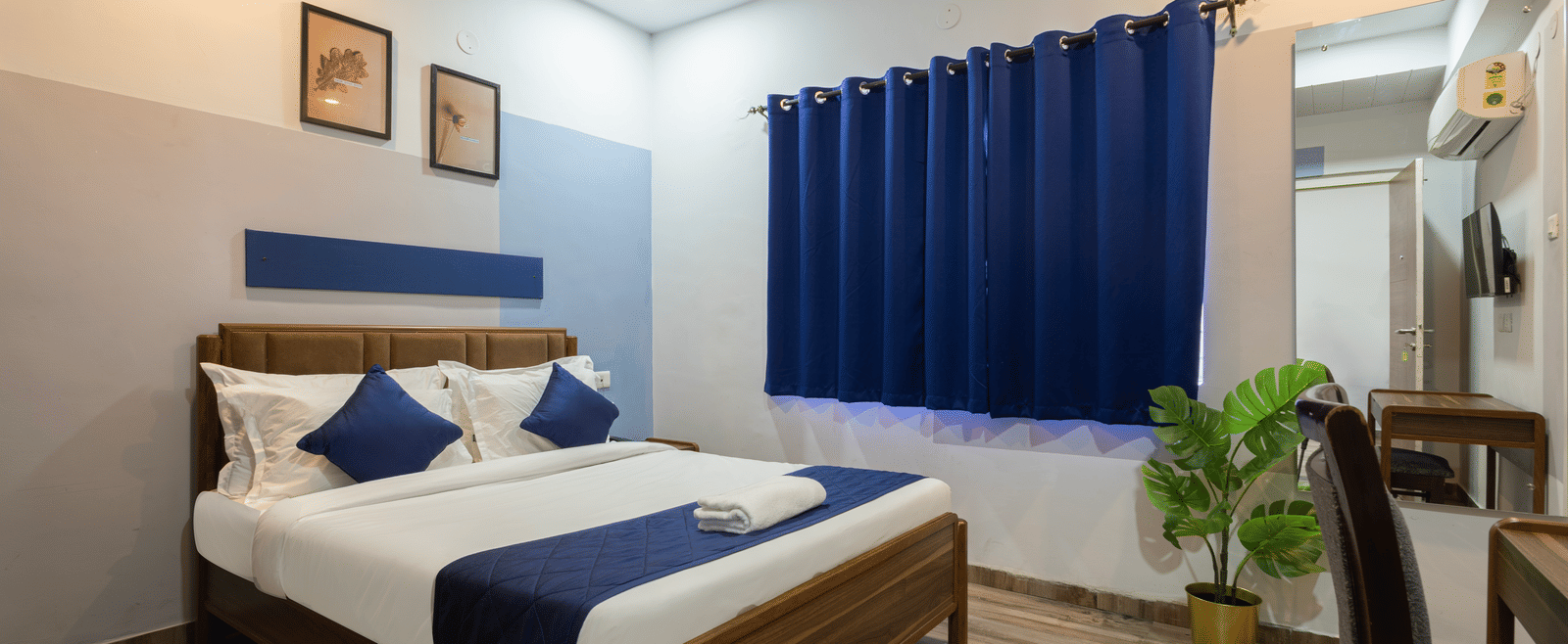 Focus of the queen size bed in the spacious 4BHK of Kove Smart Stays.