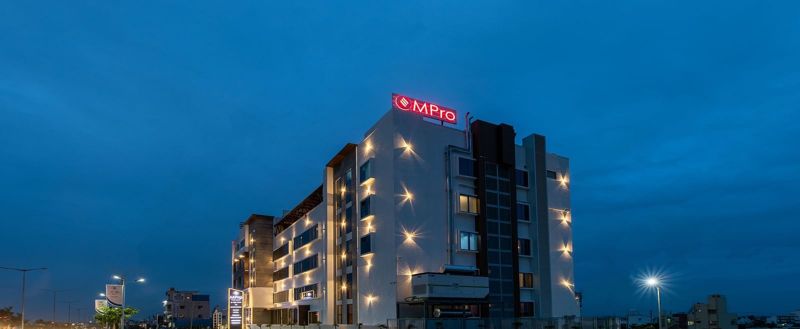 Facade of M Pro Palace with a clear sky in the background.