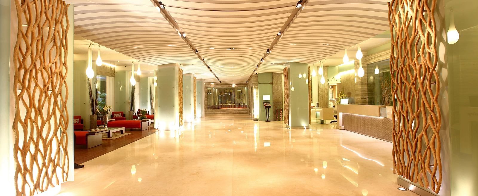 Image of the lobby at our hotel that is well-lit and has sofas on the left side. | Mirage Hotel