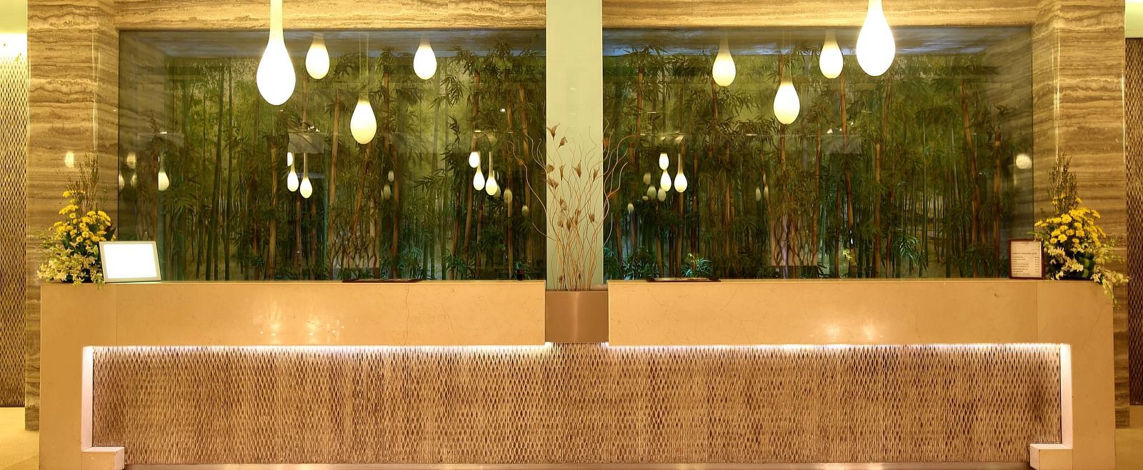 Image of the reception featuring unique lights and a front desk | Mirage Hotel
