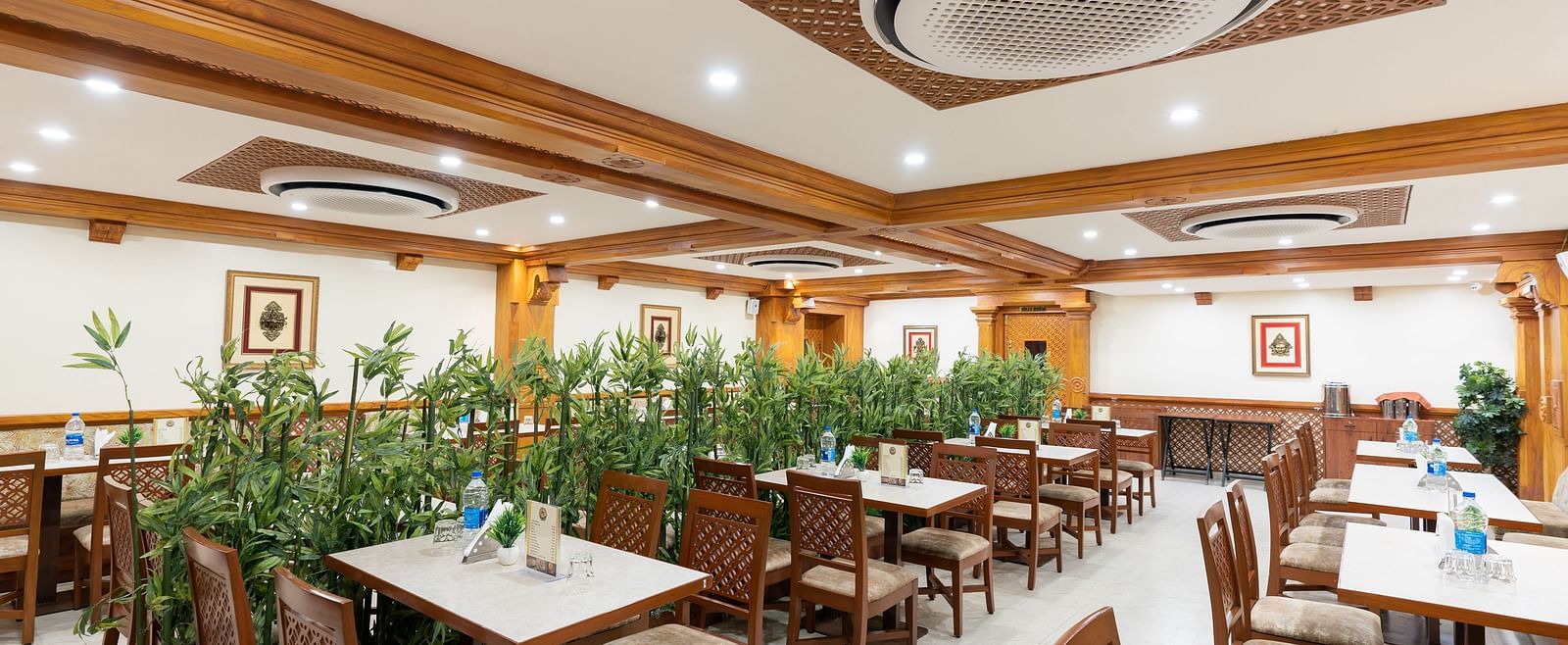 Seating arrangement in restaurant at Hotel Pai Vista, Mysore