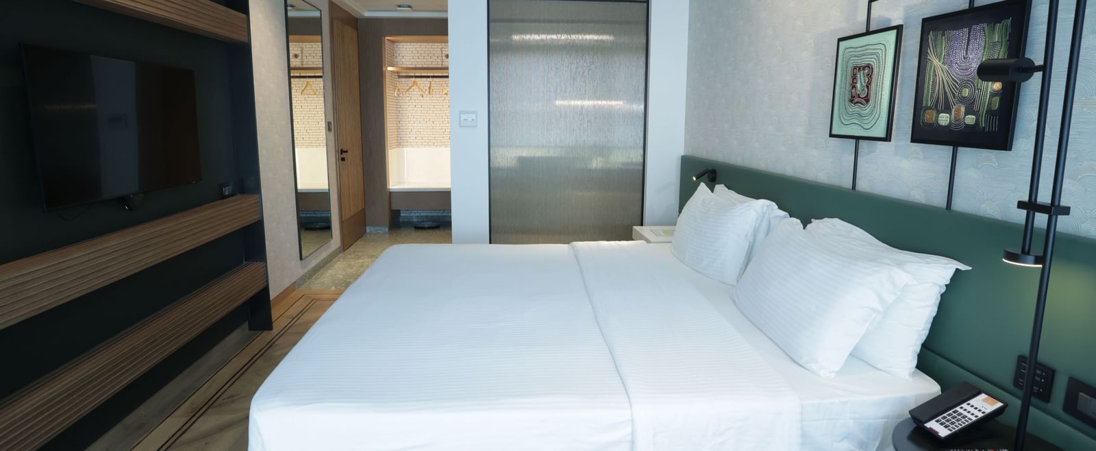Spacious bedroom with a king bed and wall decor.