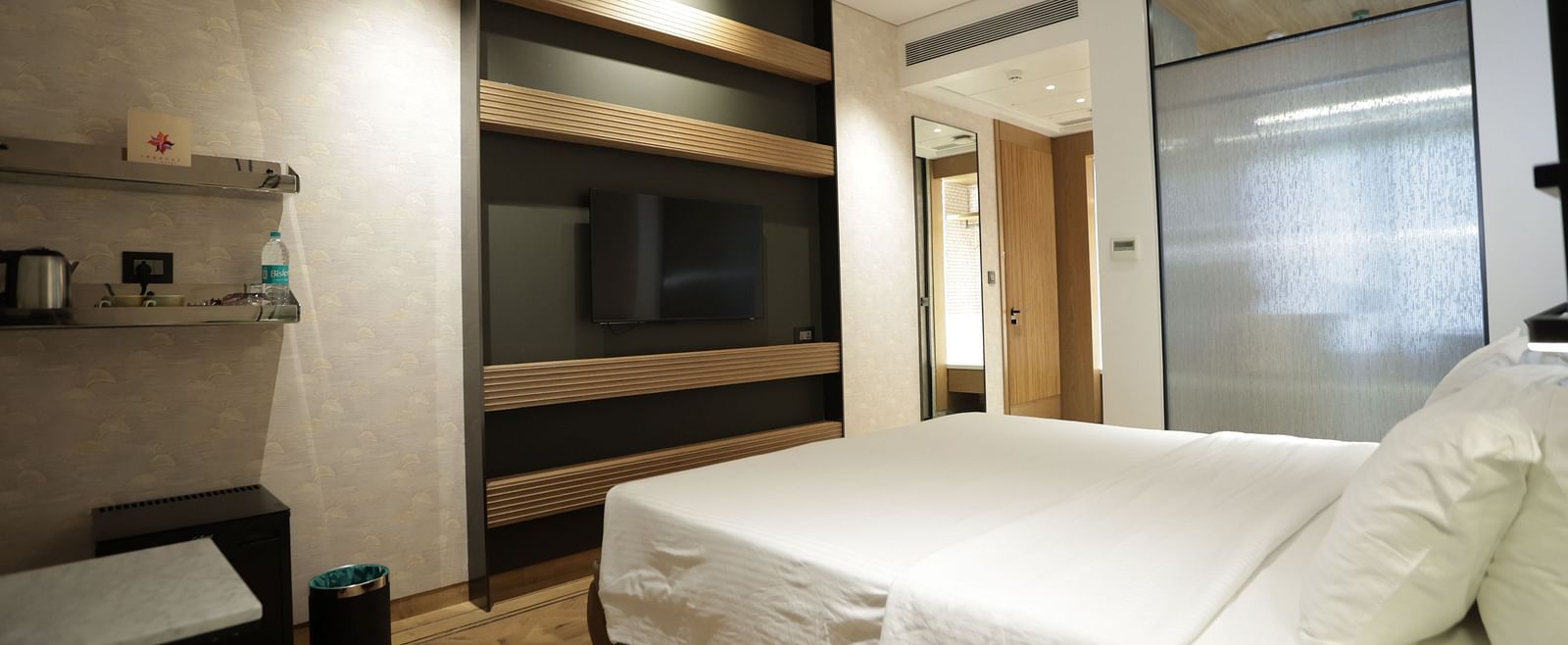 Premium accommodation at Regency Hotel, Mumbai featuring comfortable bedding, entertainment system, modern amenities and sophisticated interior design for guests.