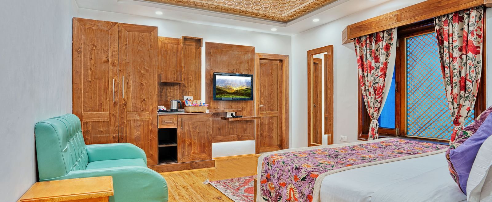 Well-appointed guest room with modern amenities and vibrant decor at Royal Comfort Regency, offering comfort in every detail.