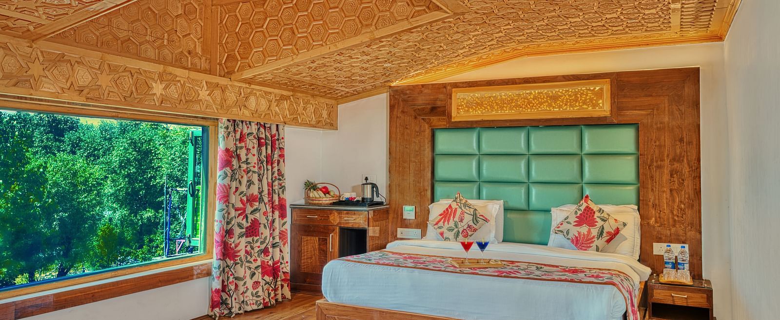 Elegant suite at Royal Comfort Regency with king bed and panoramic green views, combining comfort with a touch of nature.