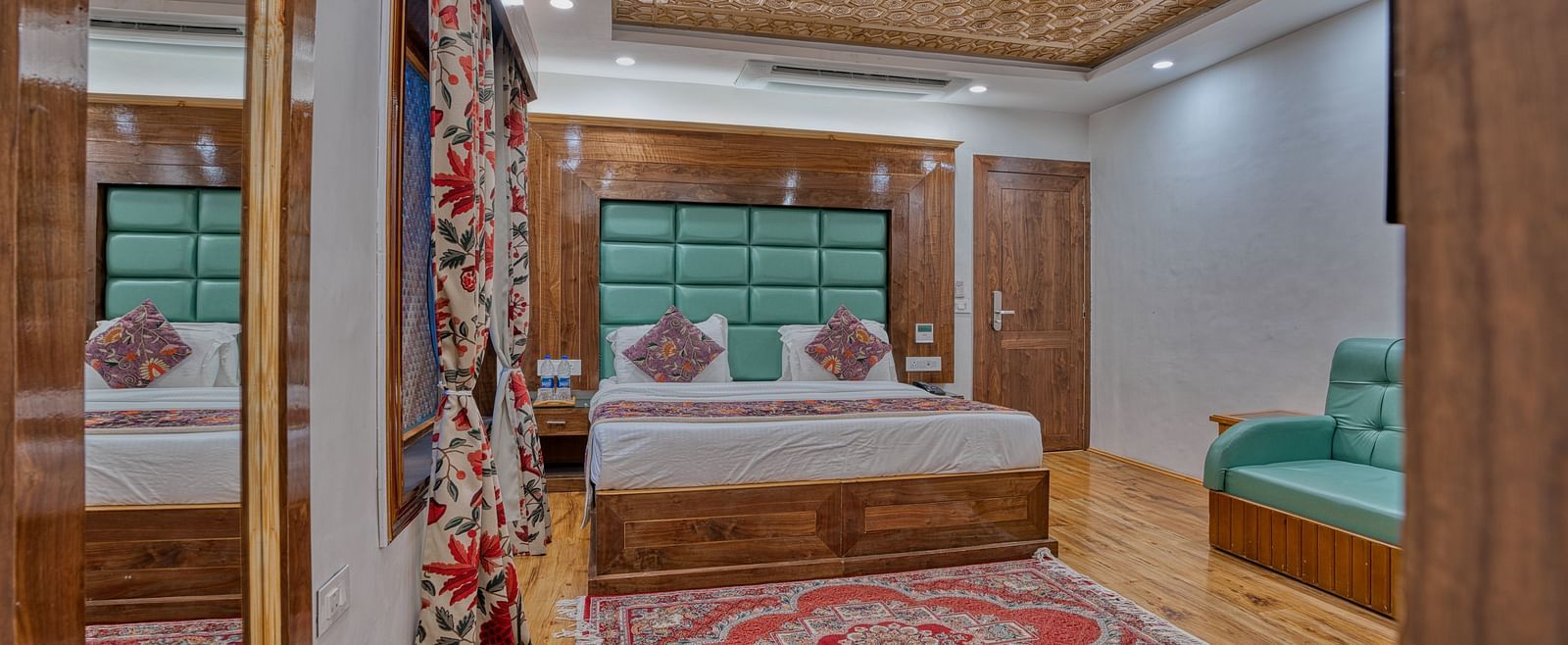 Warm and inviting bedroom at Royal Comfort Regency with classic furnishings and rich textures, offering restful hospitality.