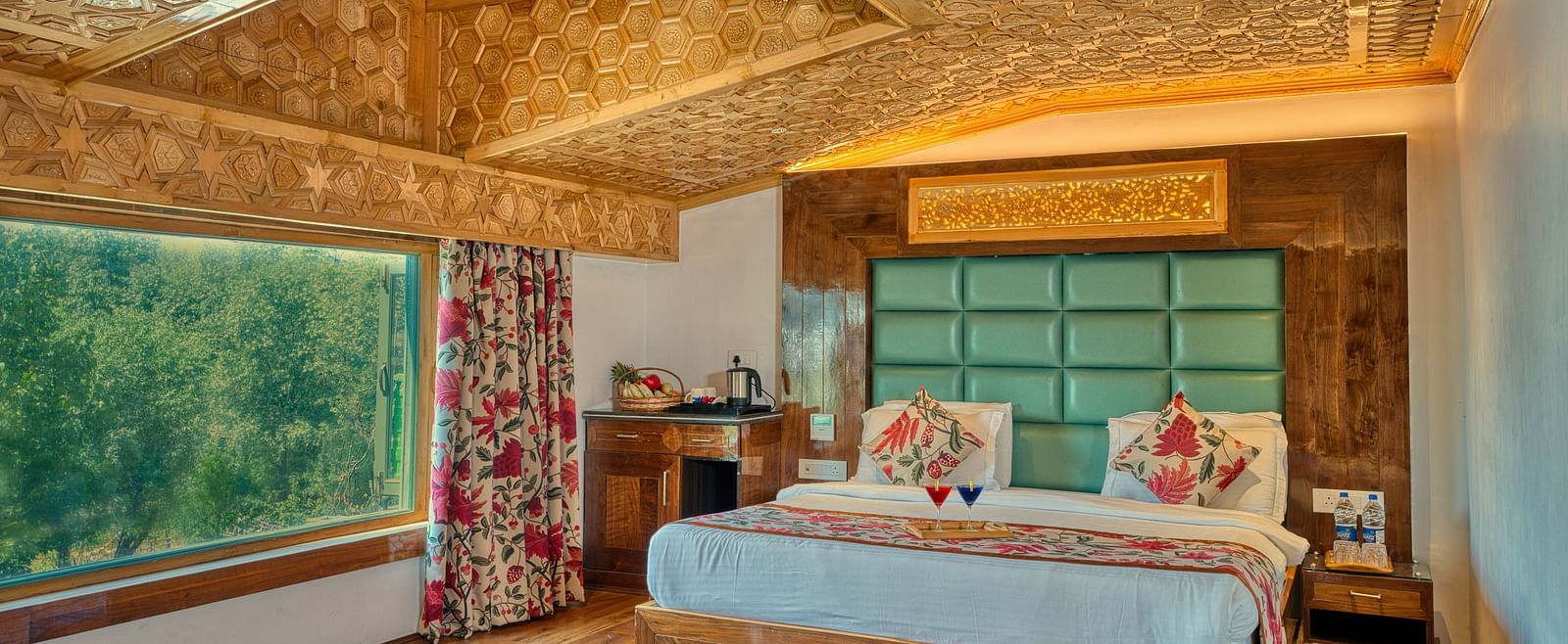 Sunlit room with lush outdoor views and refined design at Royal Comfort Regency, ideal for a refreshing retreat.