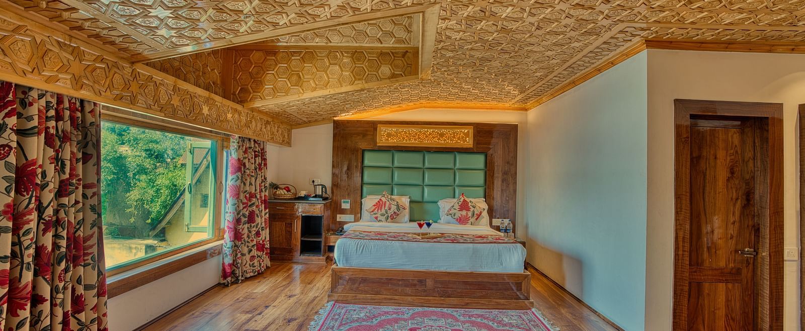Cosy bedroom with scenic window views and traditional decor at Royal Comfort Regency, perfect for a tranquil stay.