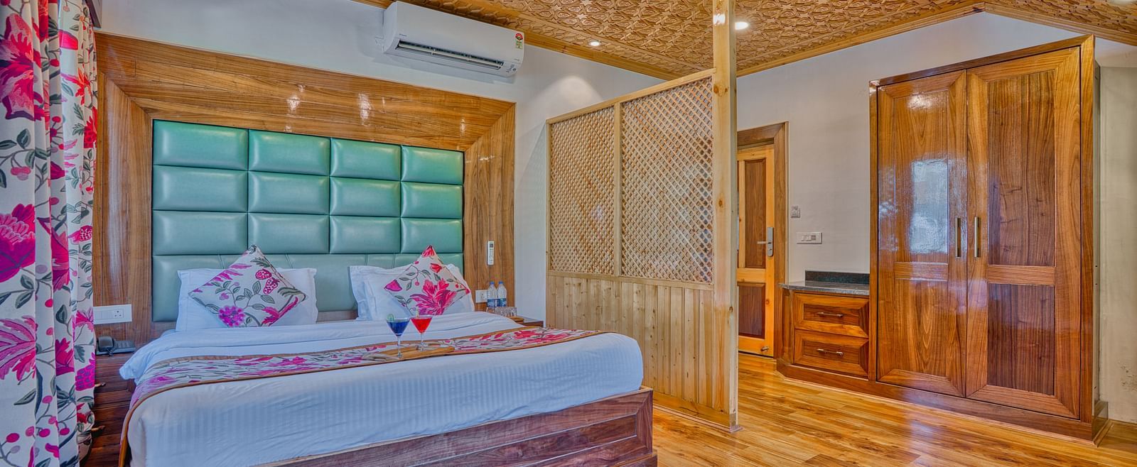 Serene bedroom at Royal Comfort Regency featuring plush bedding and ambient lighting for a luxurious, quiet escape.