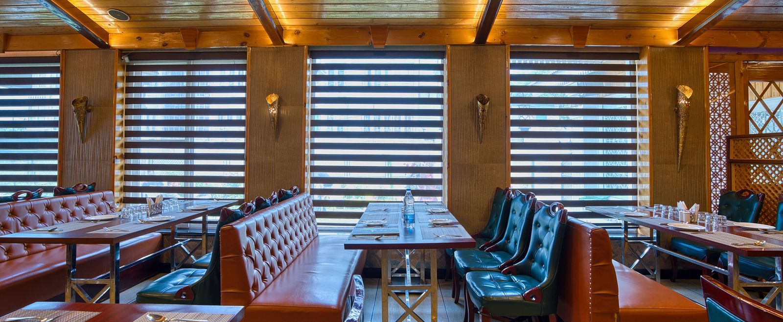 Royal Comfort Regency’s cosy restaurant seating with plush chairs and ambient lighting, perfect for relaxed meals and gatherings.