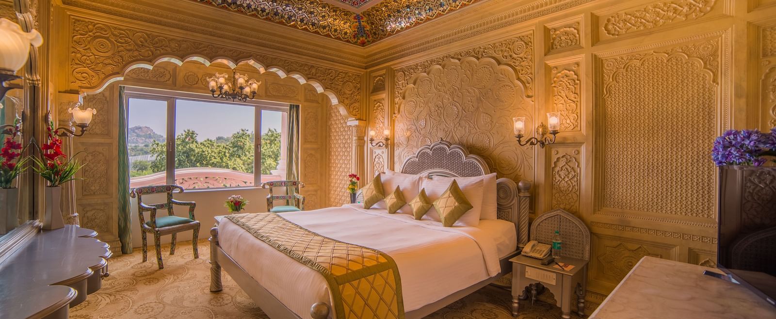 A beautifully decorated hotel room with a domed ceiling and scenic views, perfect for a luxurious stay at  Sitara Luxury Hotel in Hyderabad near Ramoji Film City.