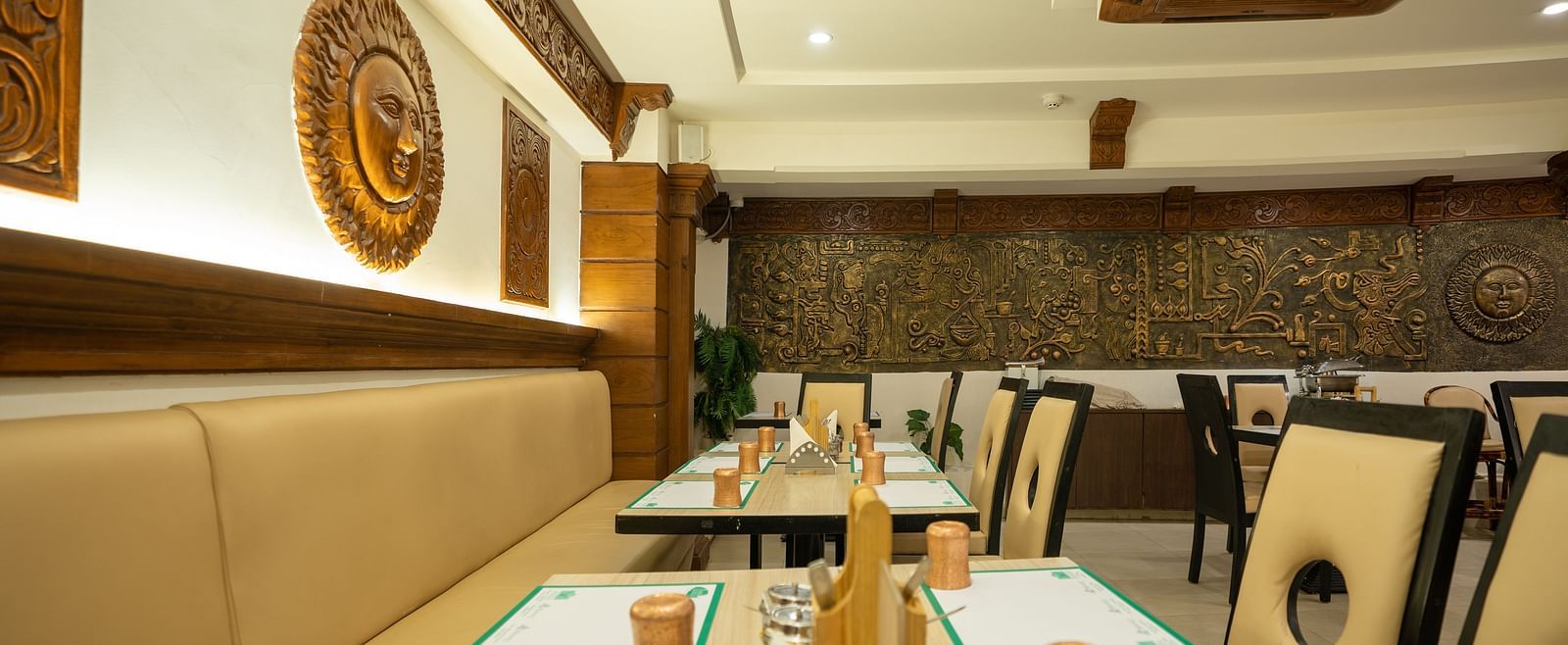An image of a seating arrangement in a Restaurant at The President Hotel, Hubli