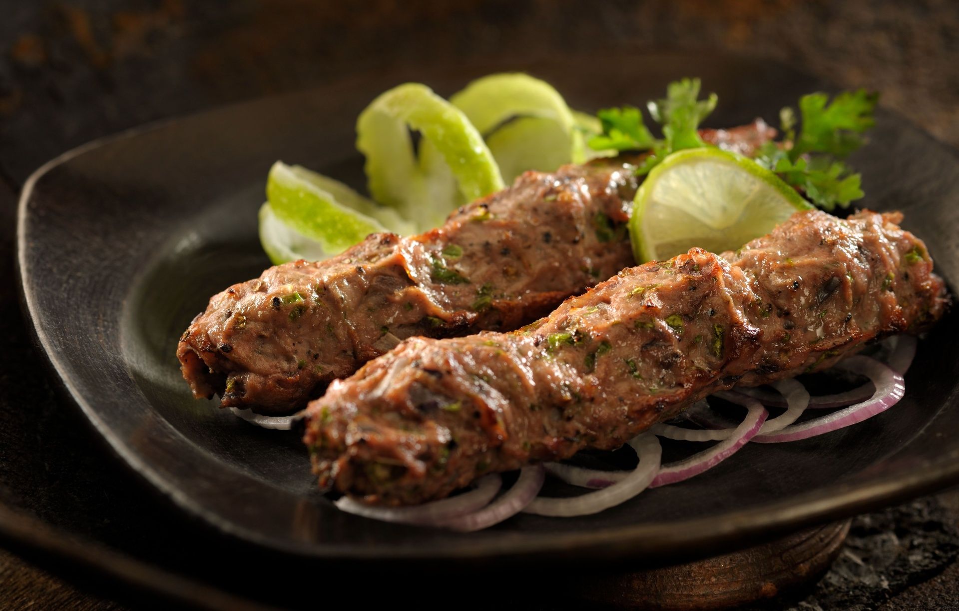 Persian Saffron Chicken Kebab with lime and onion rings.