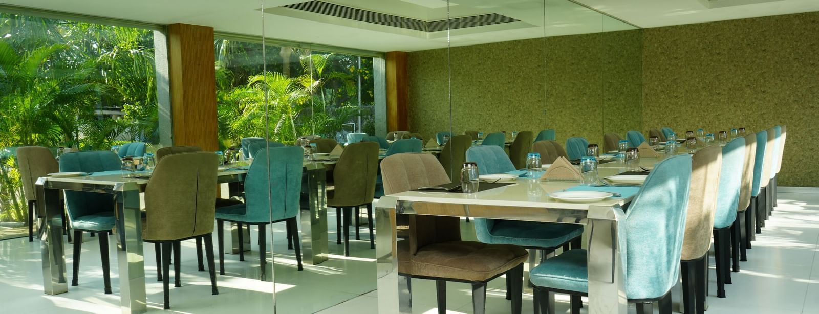 A spacious restaurant dining area with neatly arranged tables and chairs at Grande Bay Resort & Spa.