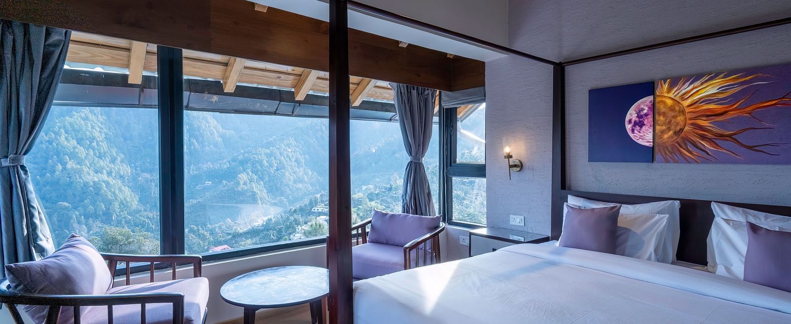 Bedroom with a four-poster bed and chairs facing a window view, with curtains pulled to the sides at The Chamomile Estate.