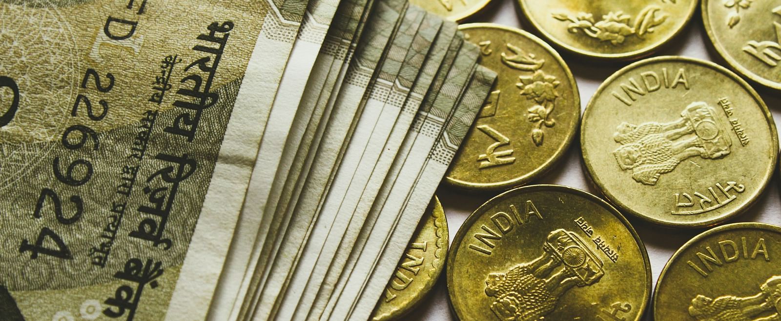 A close up shot of Indian currency notes and coins