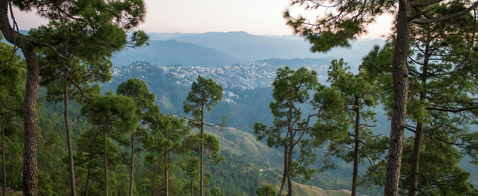 A hill side view of a city nestled between mountains