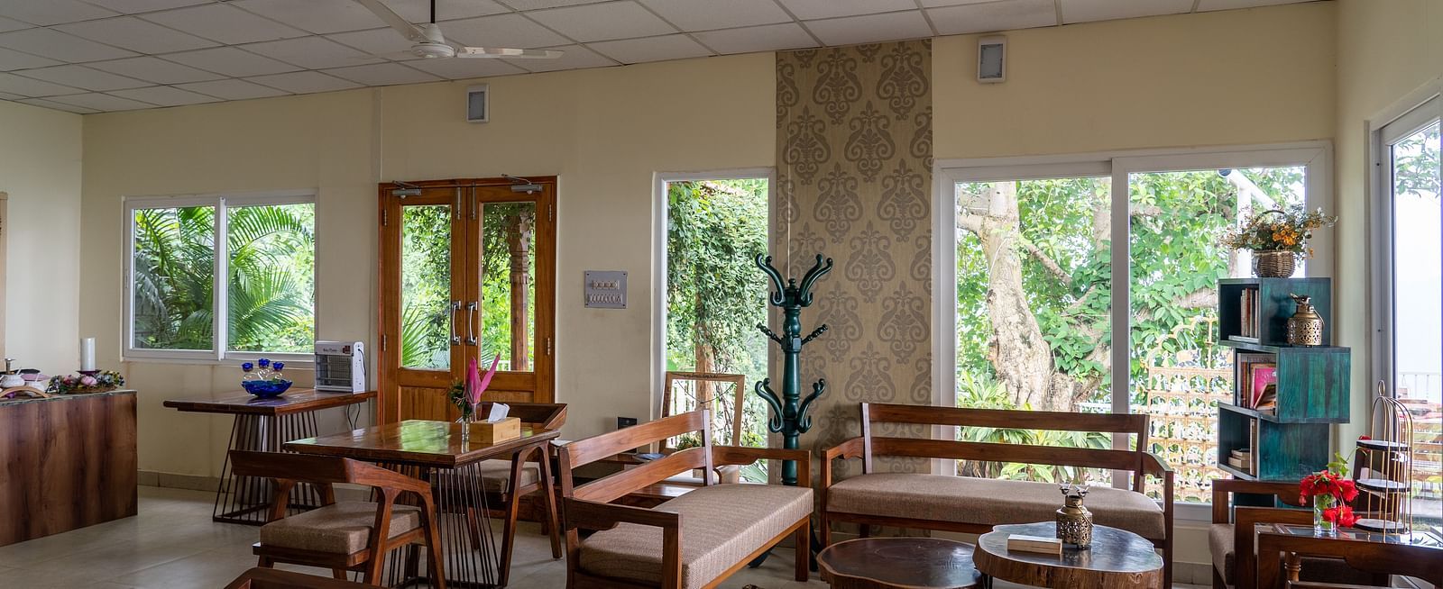 an overview of a living room with seats and tables inside one of the rooms - neer ganga resorts