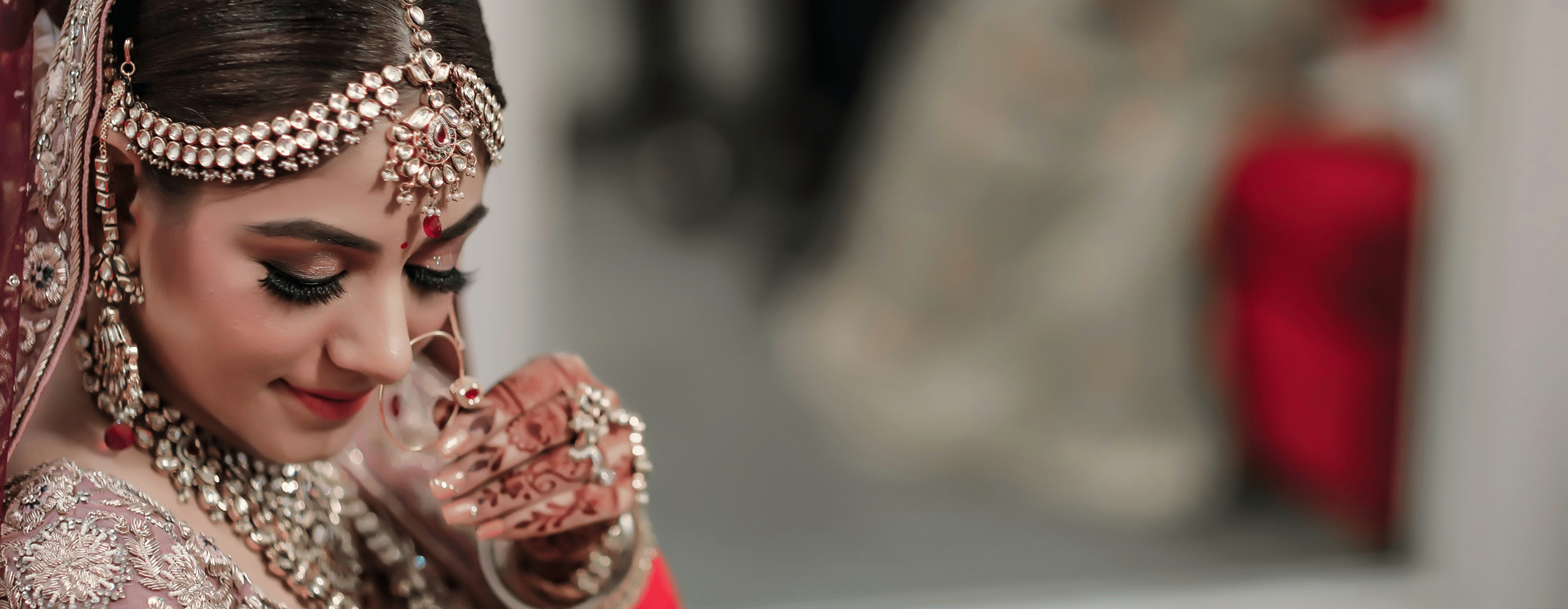 a woman dressed as a bride posing for a picture wearing many jewellery