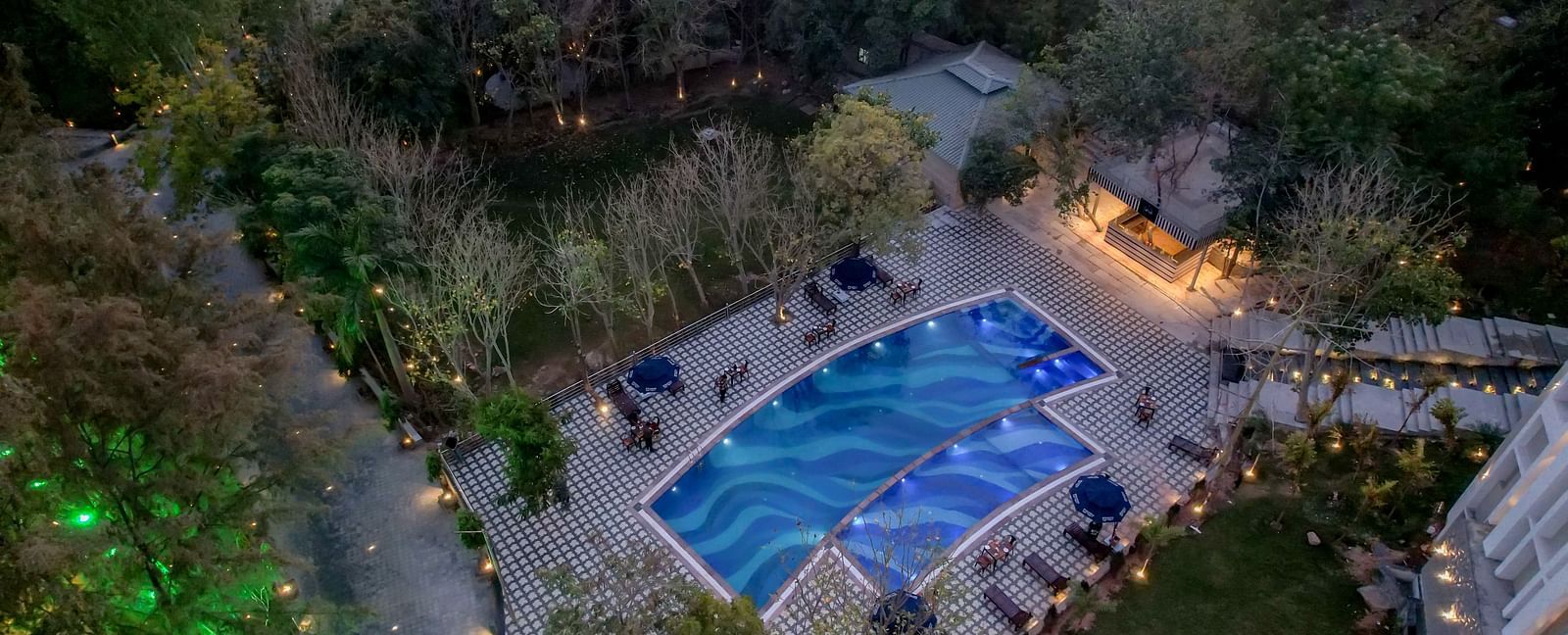 An aerial view of the swimming pool at Essentia Luxury Resort & Spa, Udaipur.
