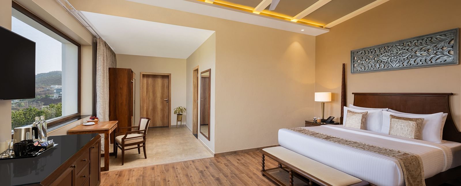 Executive Suite Room with double beds placed in front of TV at Essentia Luxury Resort & Spa, Udaipur.