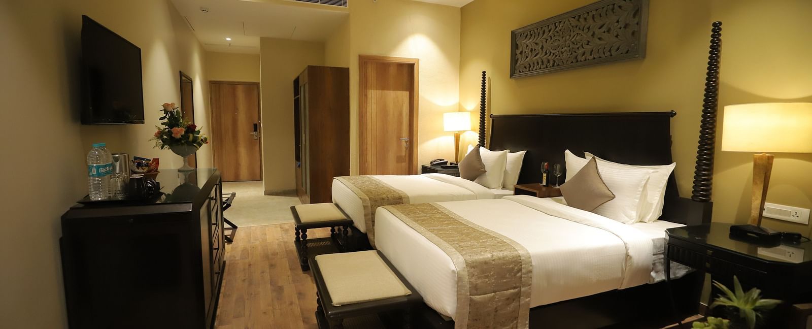 Studio Quad Room with double beds placed in front of TV at Essentia Luxury Resort & Spa, Udaipur.
