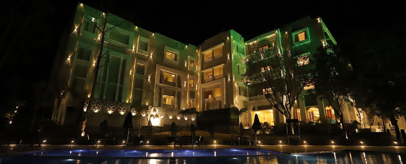 Night exterior view of Essentia Luxury Resort & Spa, Udaipur with the lights on 