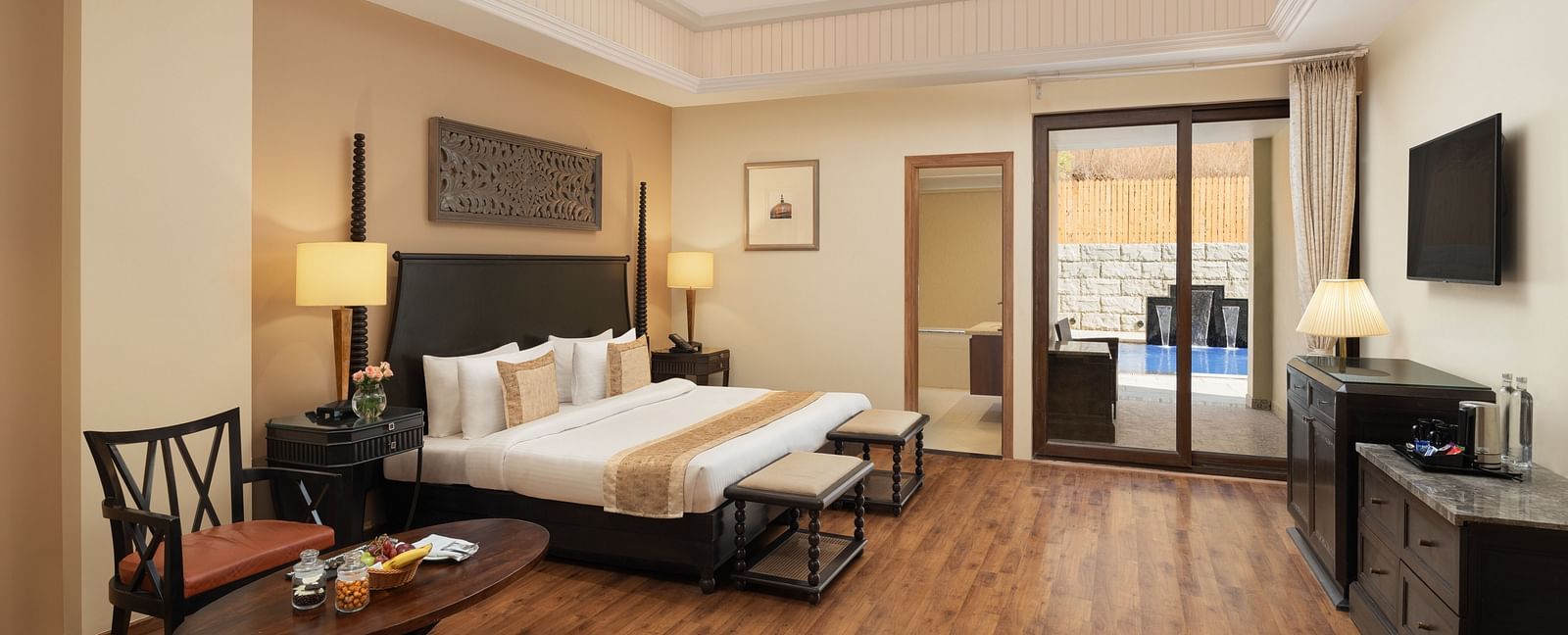 Presidential Suite Room with double beds placed in front of TV at Essentia Luxury Resort & Spa, Udaipur.
