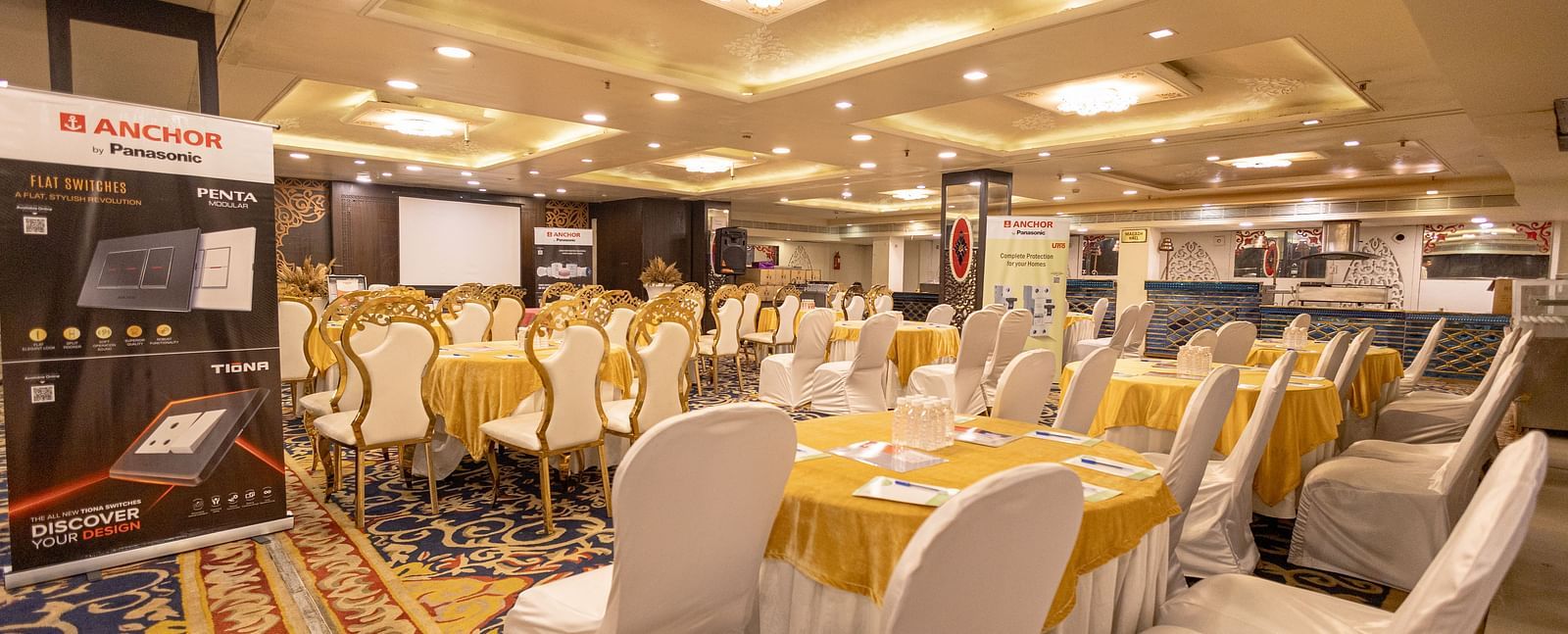 A banquet hall setup with chairs facing the stage at Hotel Ashok Nagpur.