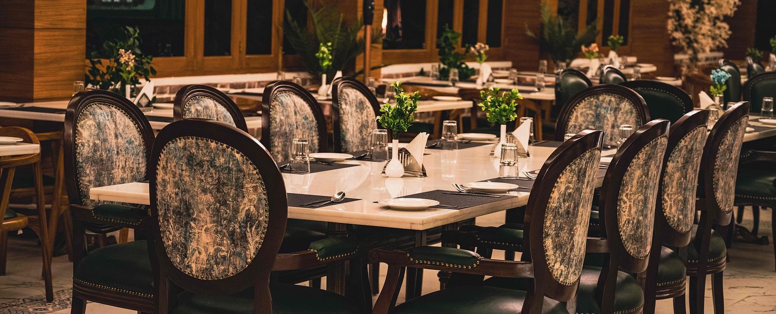 image of the alpenrose restaurant featuring an elegant dining table with well placed cutlery - the tattva boutique resort