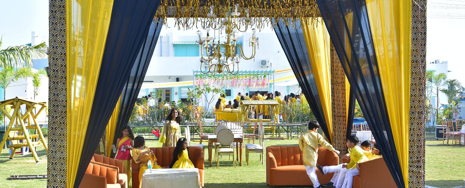 Outdoor seating lounge setup for sangeet night at Vedikant Resorts The Mallard Corbett with clear blue sky in the background.