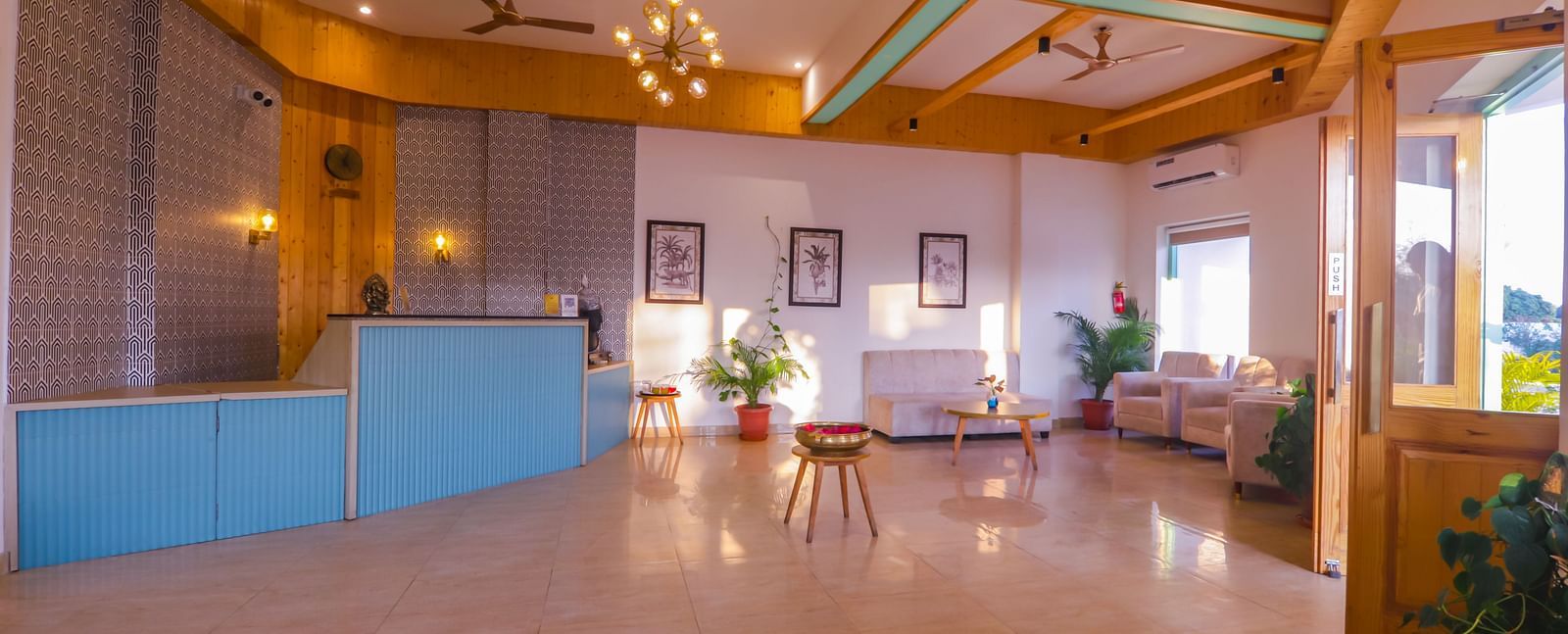 A spacious and well-lit lobby area at Vedikant Resorts The Mallard Corbett features tiled flooring and comfortable seating.