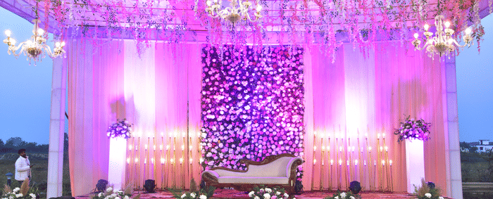 Grand wedding stage with pink floral backdrop