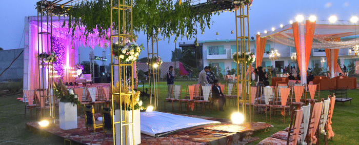Evening wedding lawn with floral lights and canopy