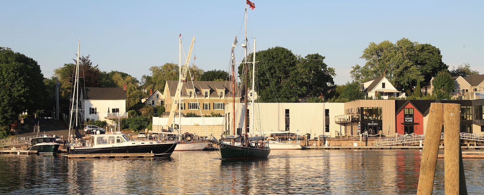 Picturesque harbour view with moored boats and waterfront buildings near Hartstone Inn