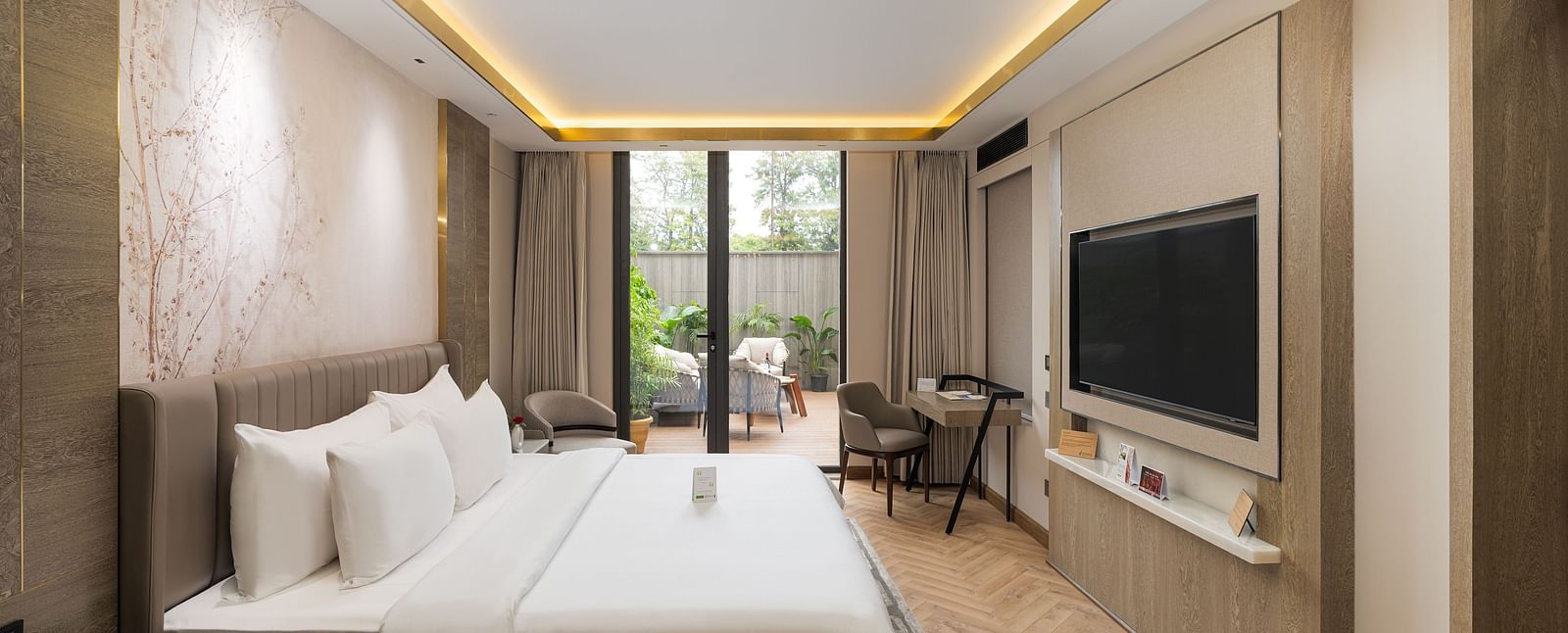 Nirvana Suite bedroom furnished with two queen size beds, tasteful decor, and ample natural light - Nirvana Luxury Hotel, Ludhiana