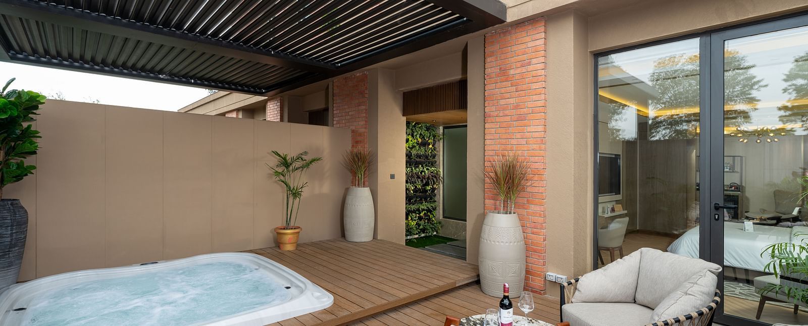 Nirvana Suite patio boasting a relaxing jacuzzi, comfortable outdoor seating, and a view of the hotel's surroundings - Nirvana Luxury Hotel, Ludhiana