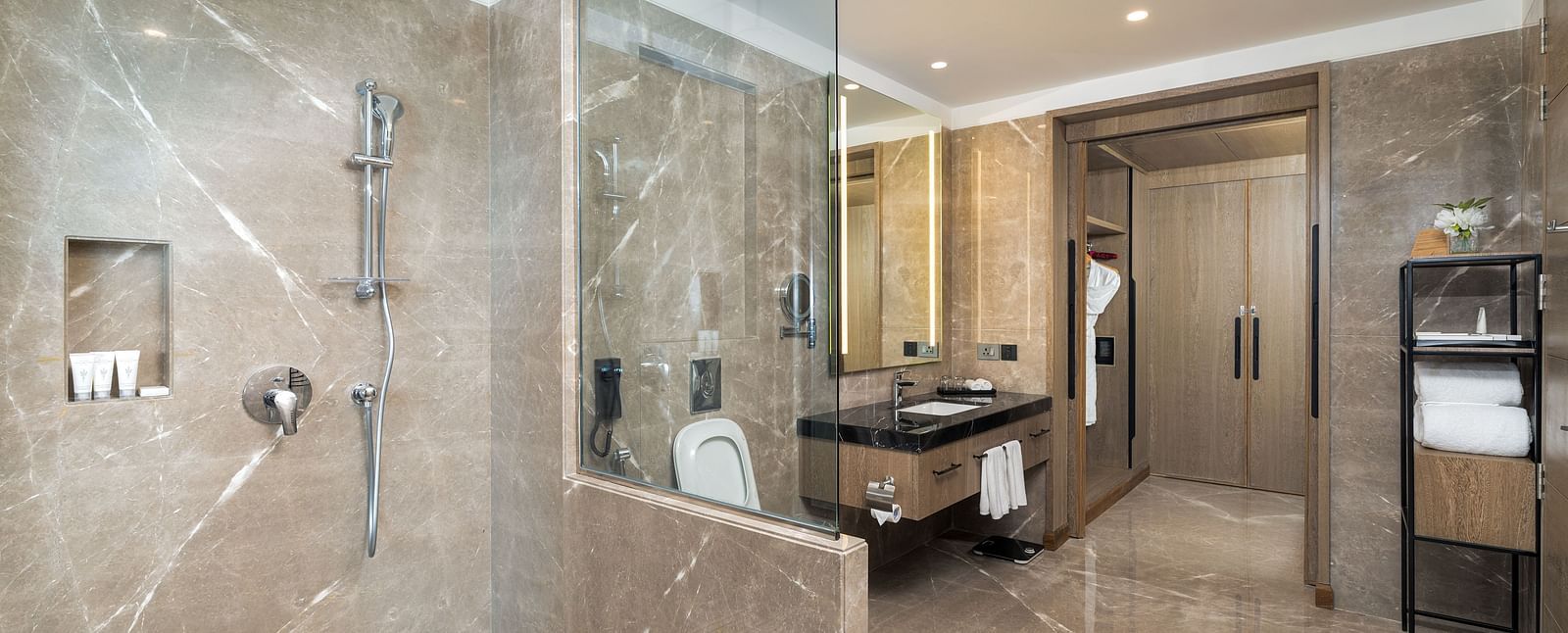 Nirvana Suite bathroom showcasing a sleek glass-enclosed shower, contemporary sink fixtures, and refined design - Nirvana Luxury Hotel, Ludhiana