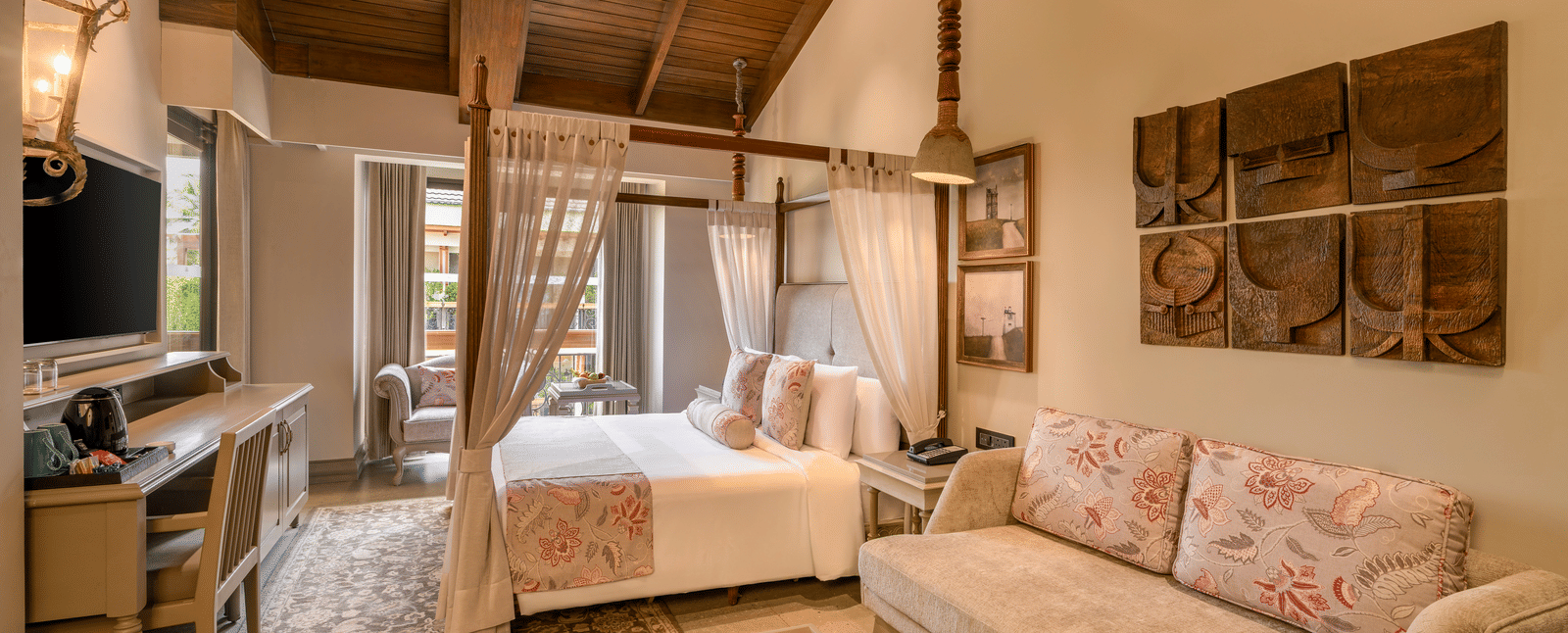 Full-view shot of the Executive Room featuring common seating area along with a double bed in the room at The Evren, Vagator.