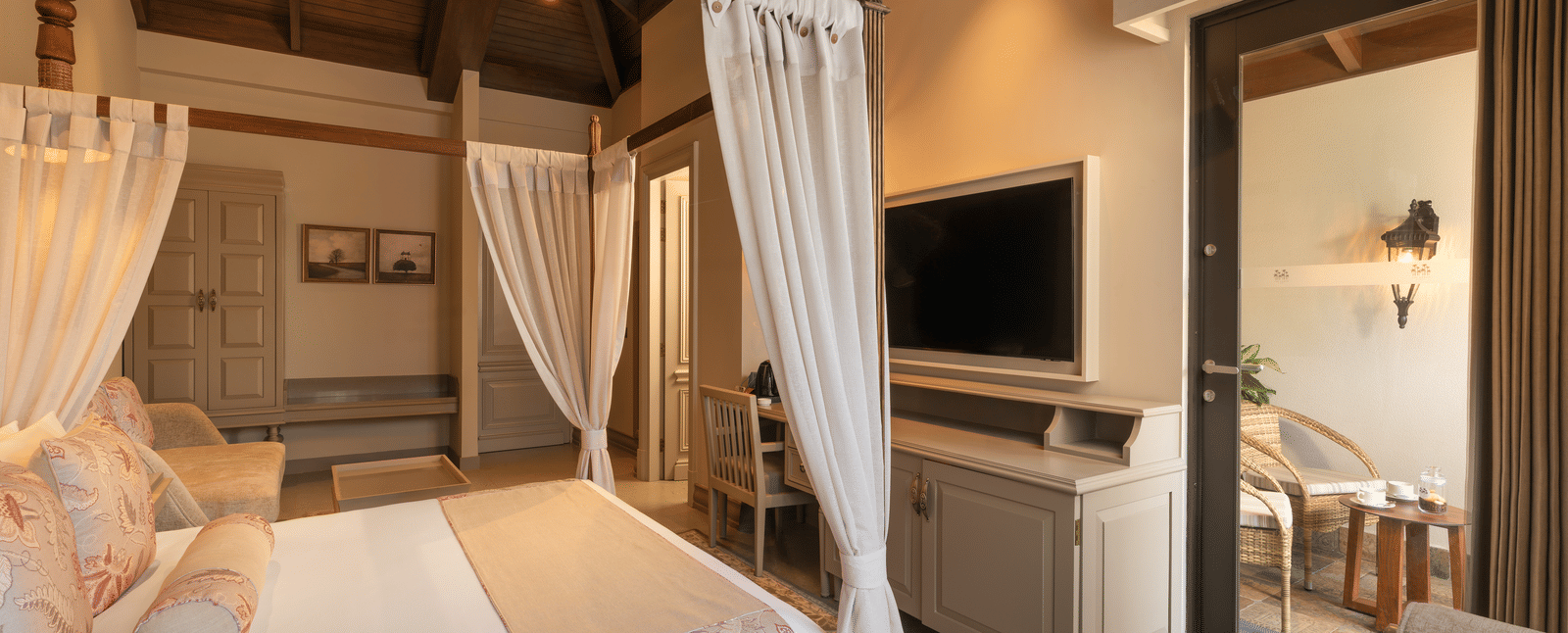 Side view of the Executive Room featuring a double bed with a television unit in front of it at The Evren, Vagator.