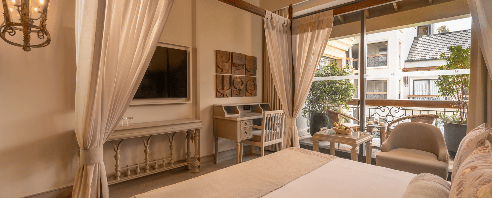 Corner view of the Premium Room featuring a double bed and wall-mounted television at The Evren, Vagator.
