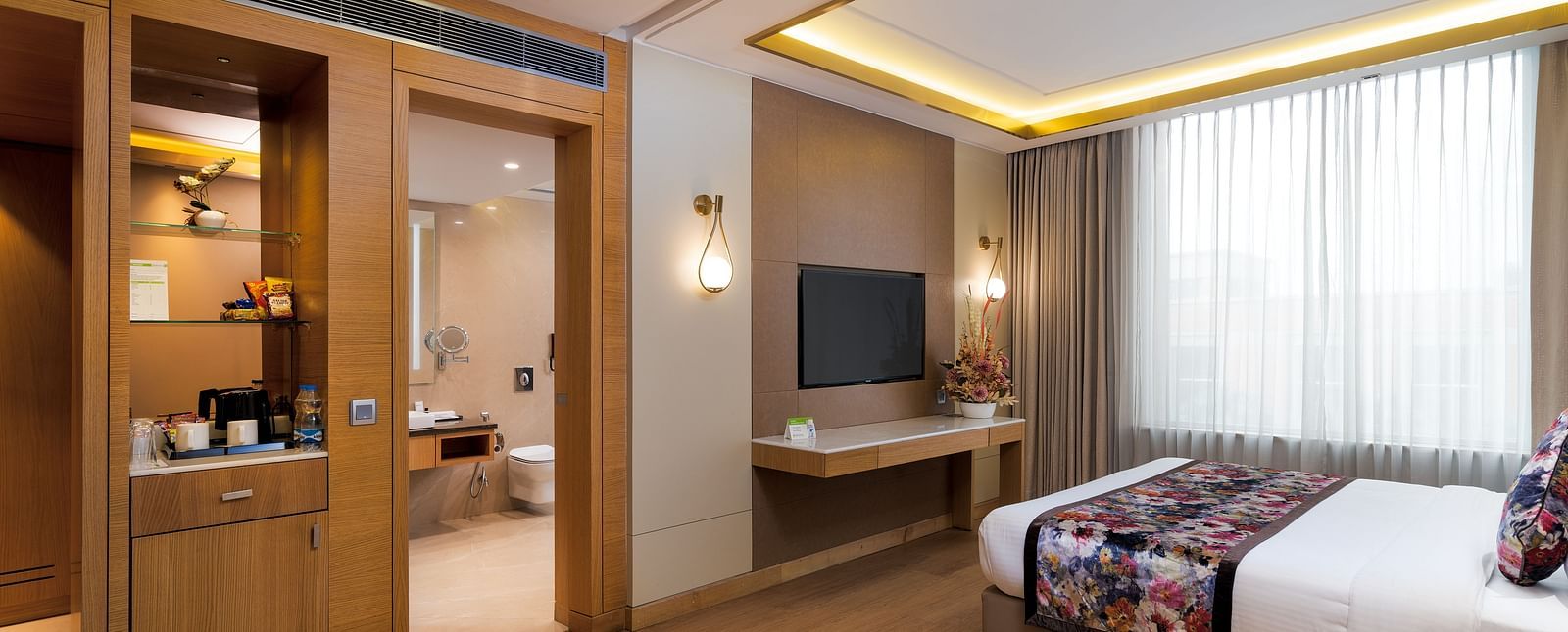 The Club Room at Nirvana Luxury Hotel, Ludhiana with a single bed and a television.
