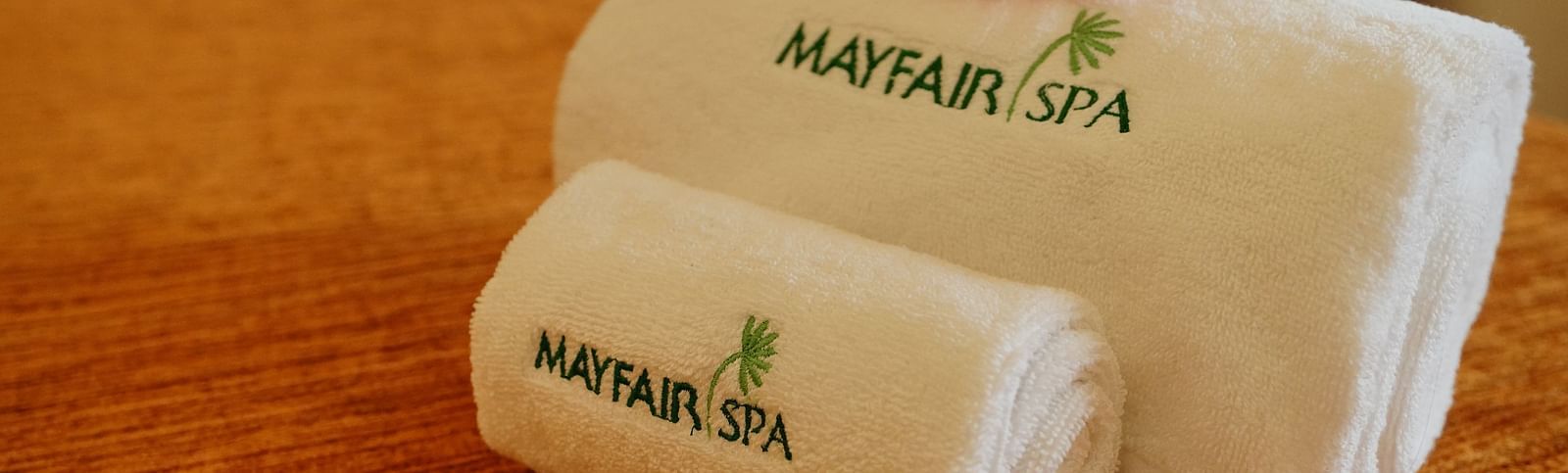 two folded towels with the name mayfair spa printed on them - Mayfair Tea Resort, Siliguri 