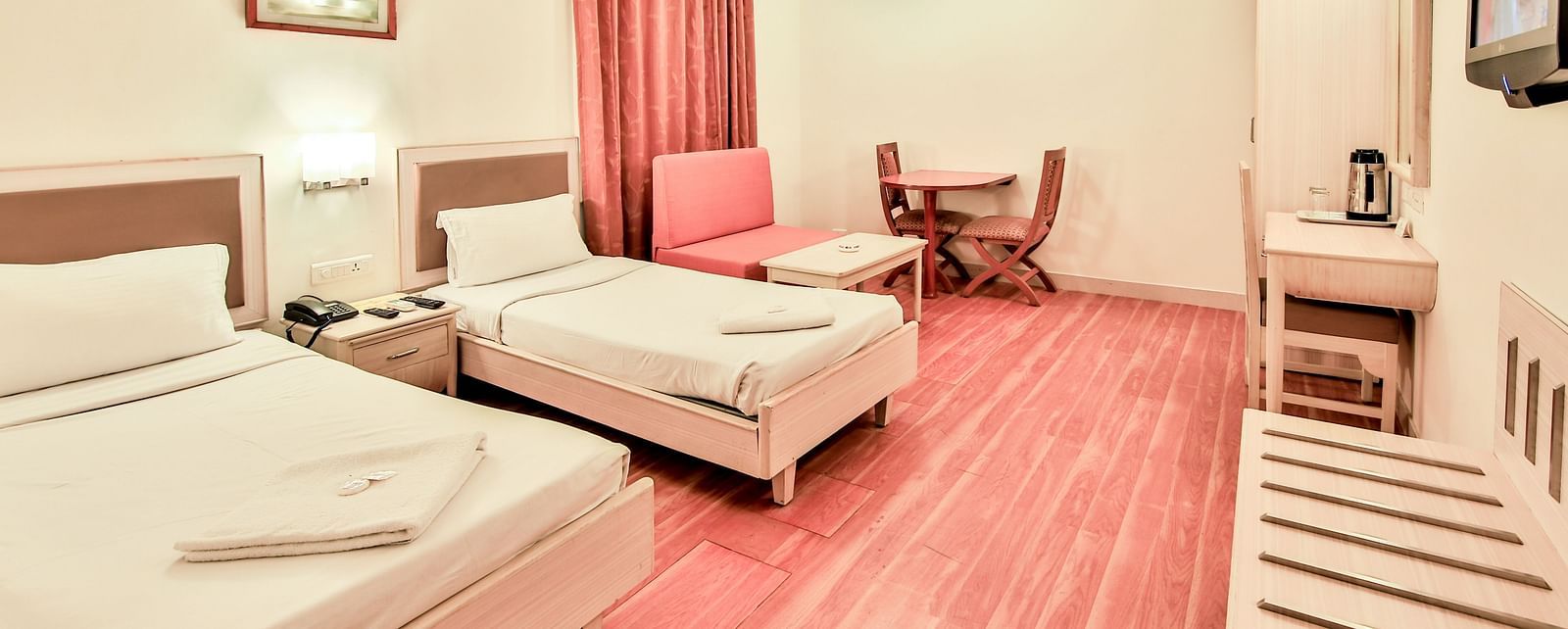 Superior Room at Hotel Shantiniketan with twin beds and a television in Hyderabad near Ramoji Film City.