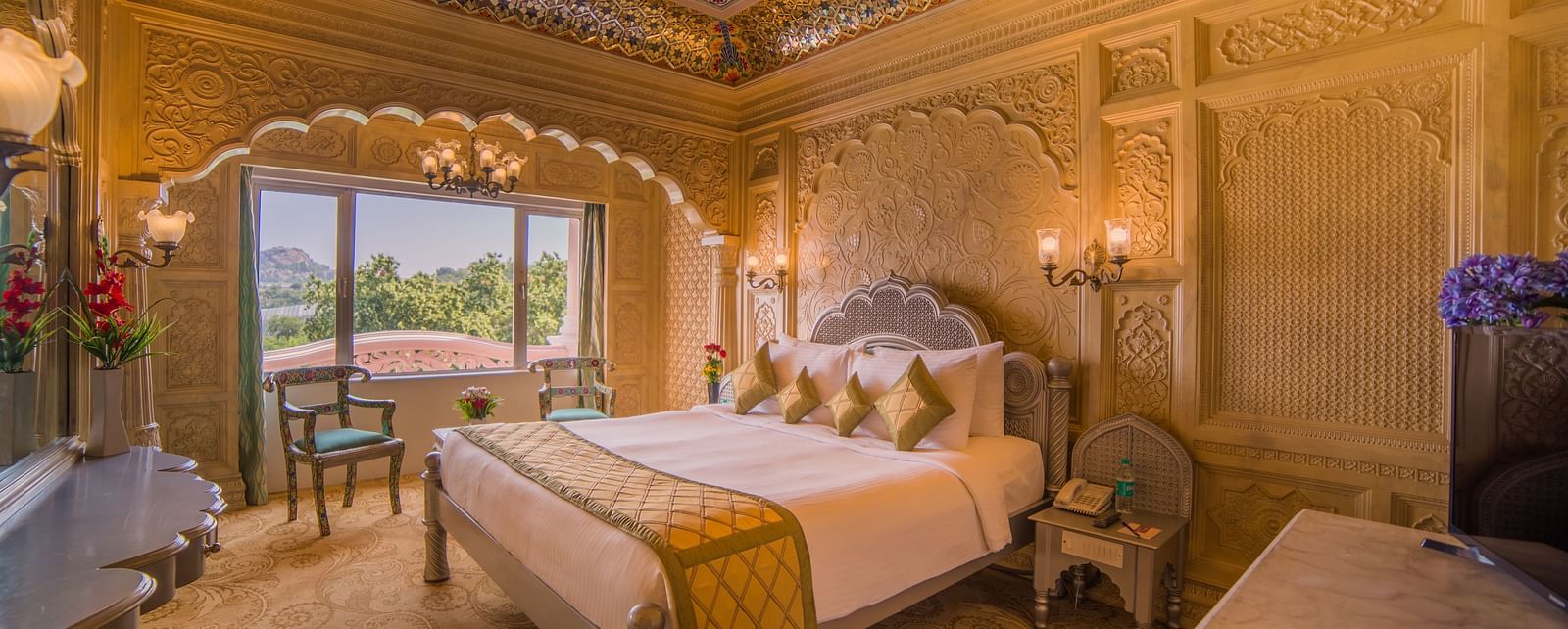 A beautifully decorated hotel room with a domed ceiling and scenic views, perfect for a luxurious stay at  Sitara Luxury Hotel in Hyderabad near Ramoji Film City.