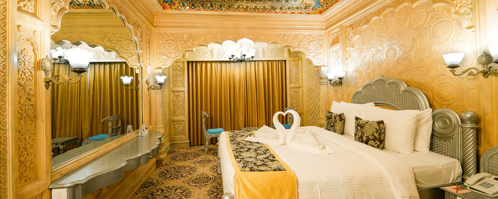 Themed room at Sitara Luxury Hotel in Hyderabad near Ramoji Film City with a king size bed and side tables